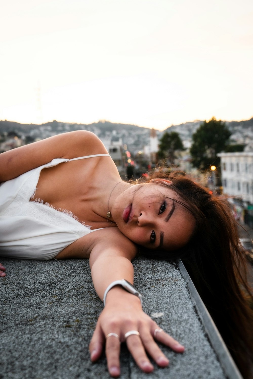 woman lying on rooftop during day