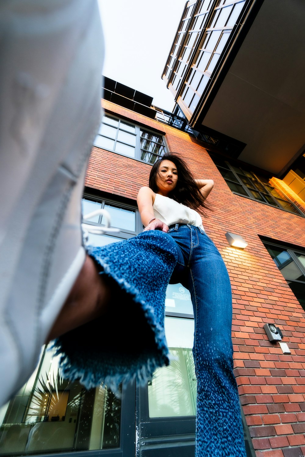 woman wearing white blouse and blue jeans