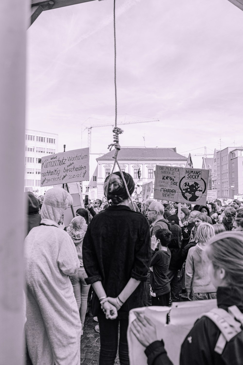 a crowd of people standing around each other