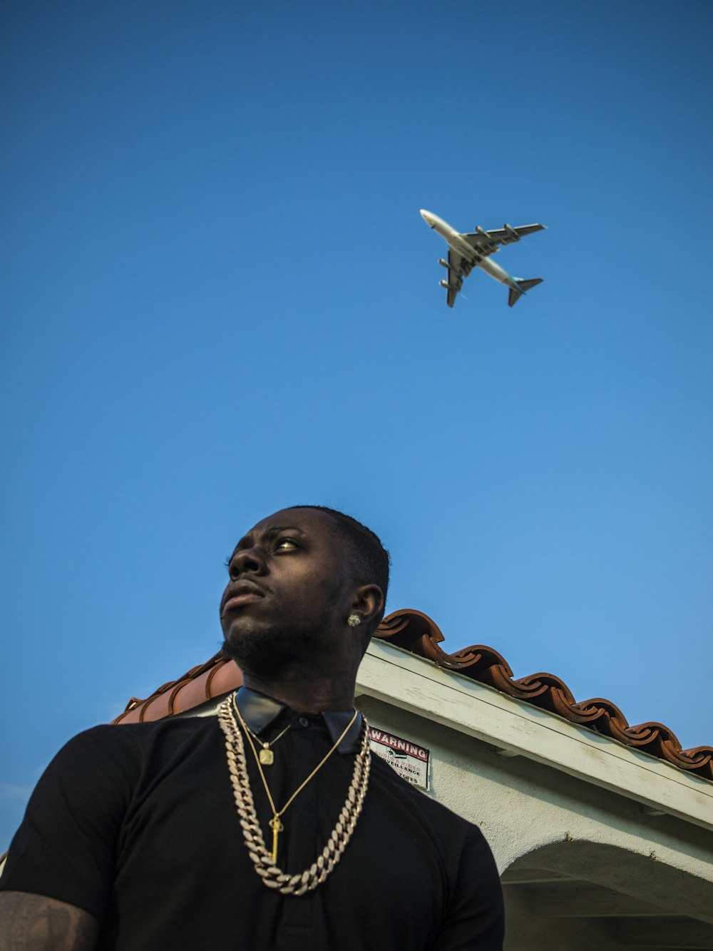 man wearing necklaces