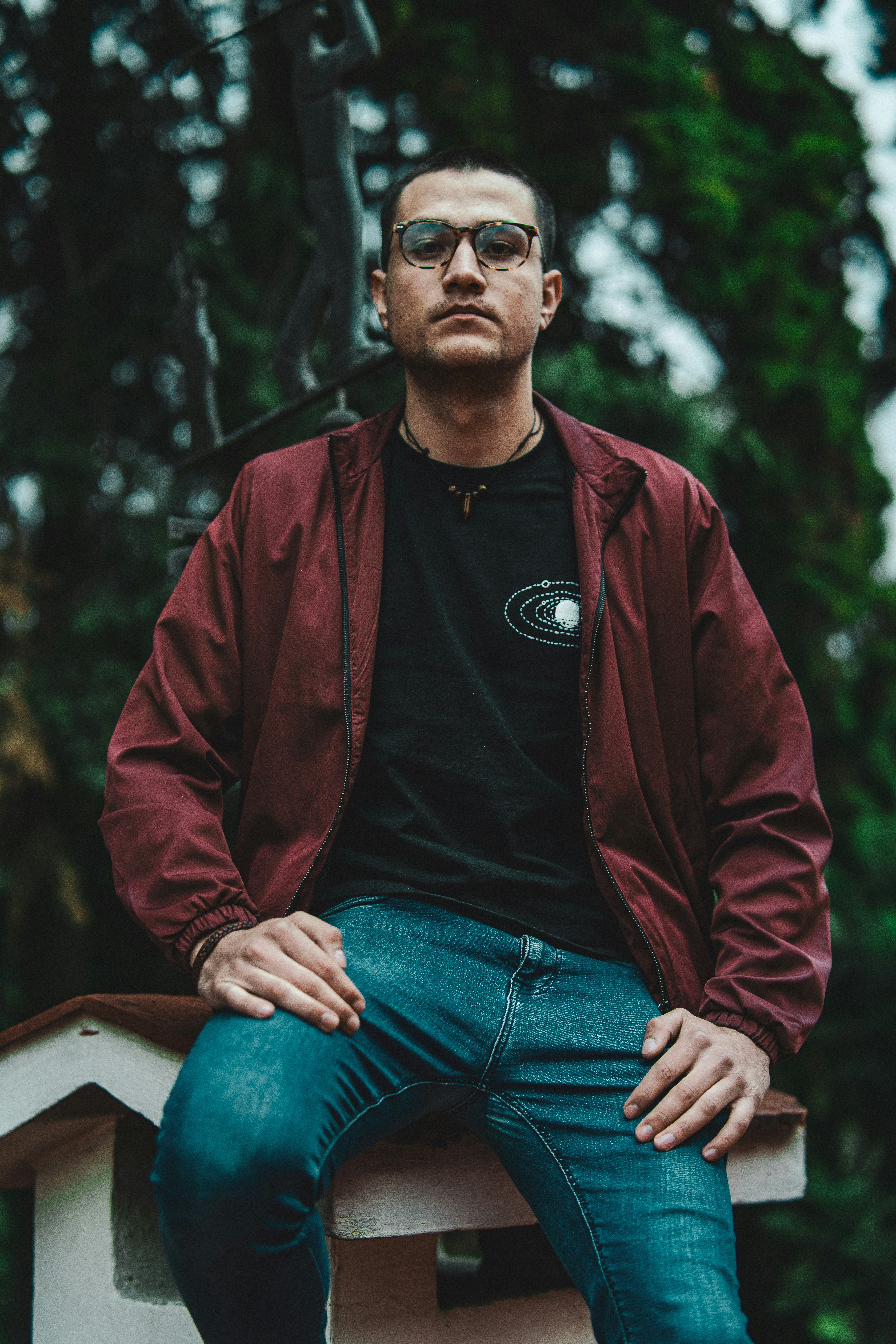 man wearing red zip-up jacket during daytime