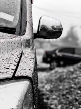 Close-up of water droplets on a freshly washed car surface.