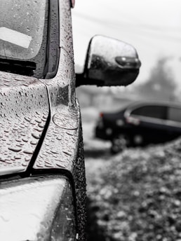 Close-up of water droplets on a freshly washed car surface.