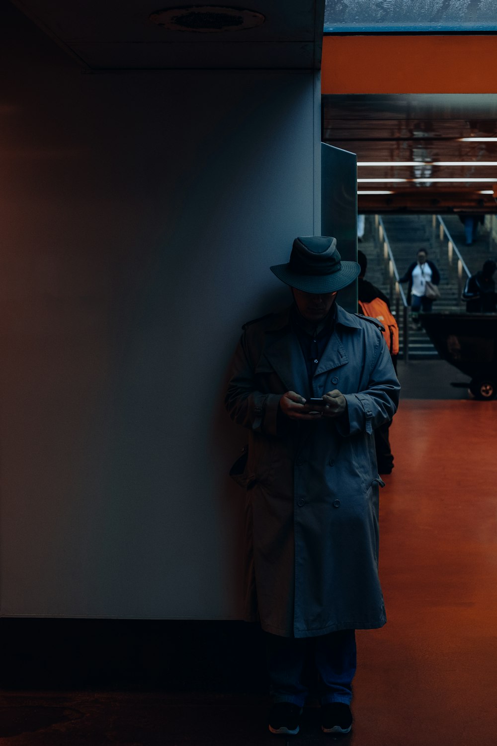 man standing against the corner of wall