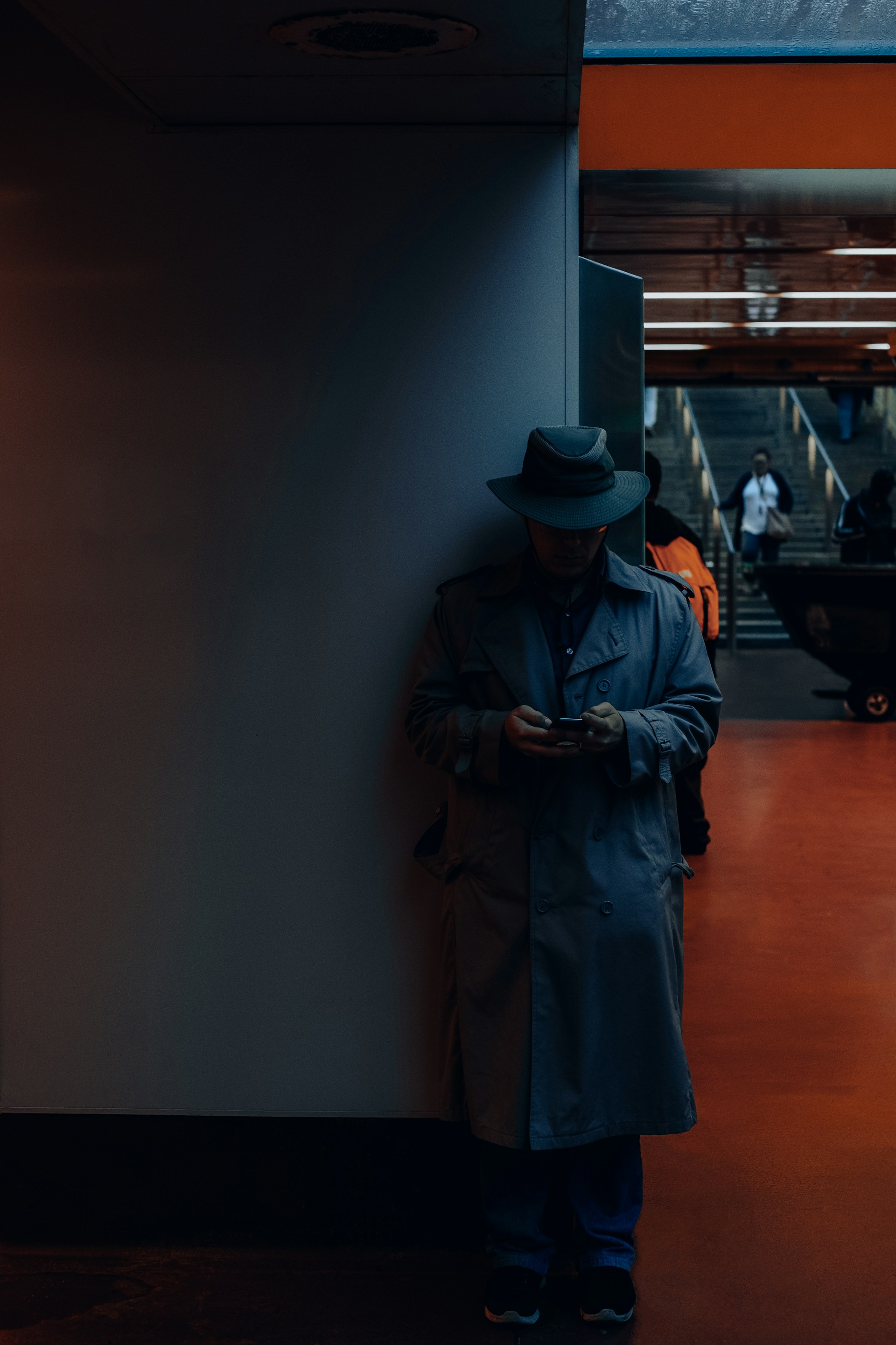 man standing against the corner of wall