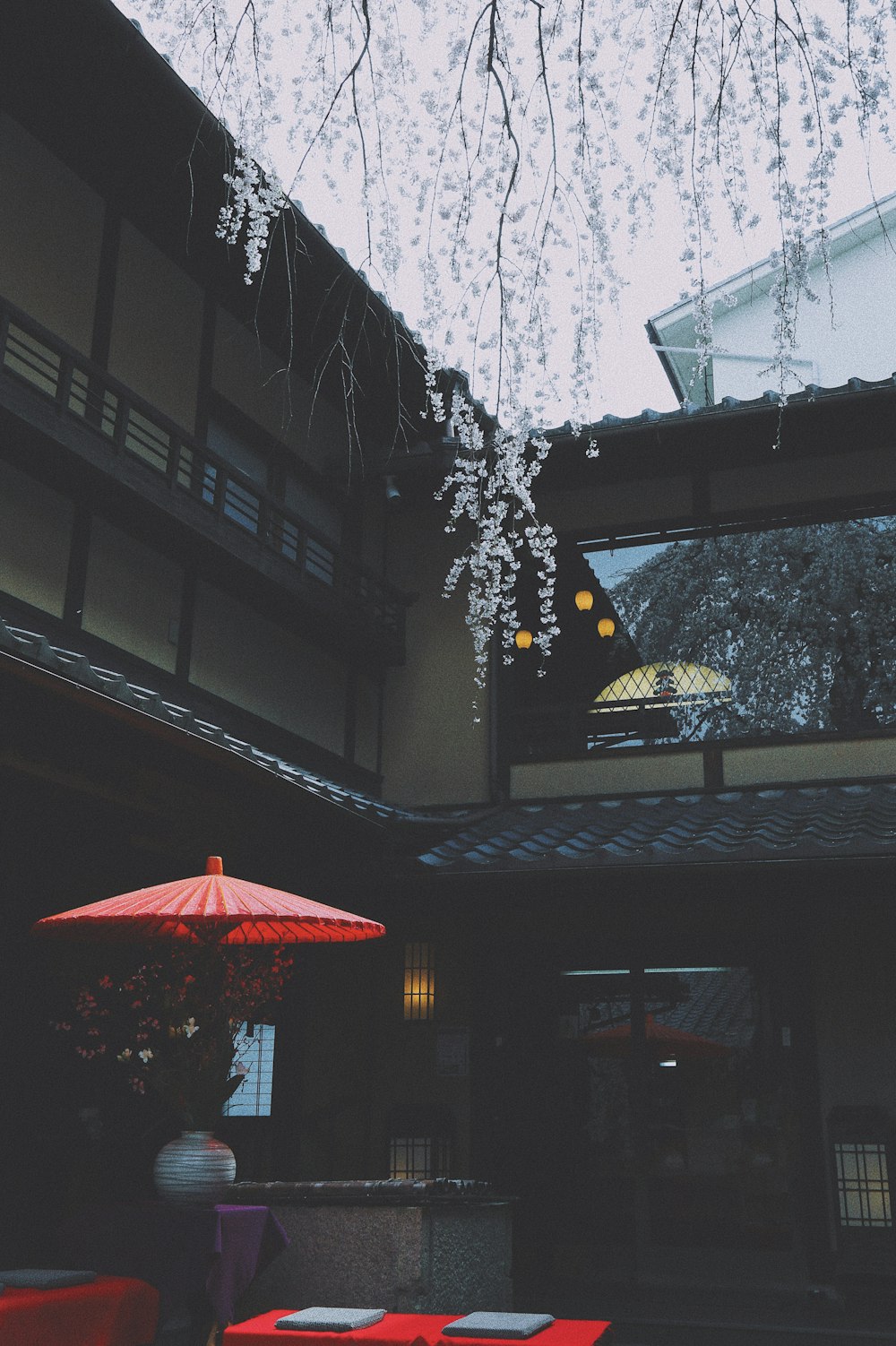 gray and white house and red umbrella