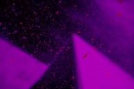 A cosmic background featuring stars and numerological symbols.