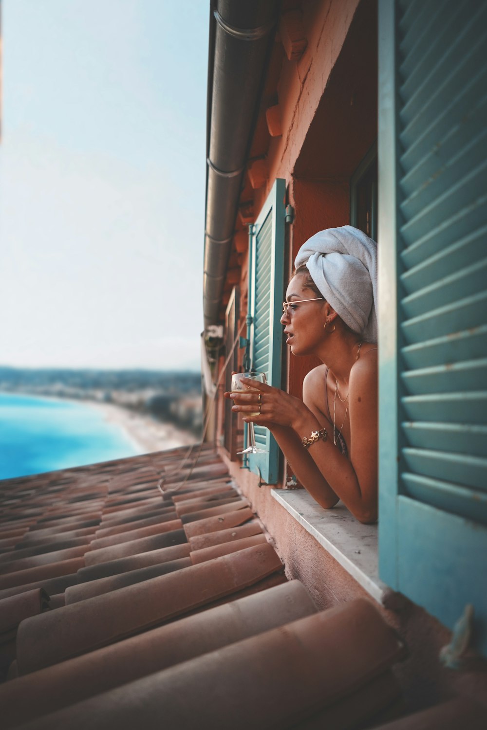 woman on window holding glass