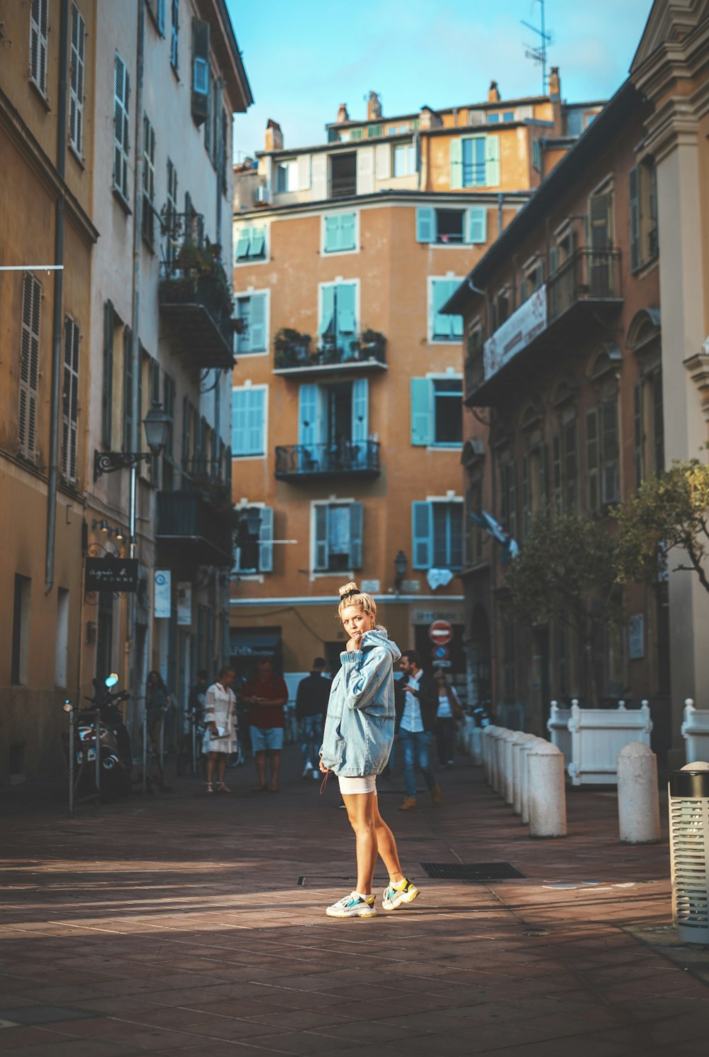 woman standing in middle of buildings