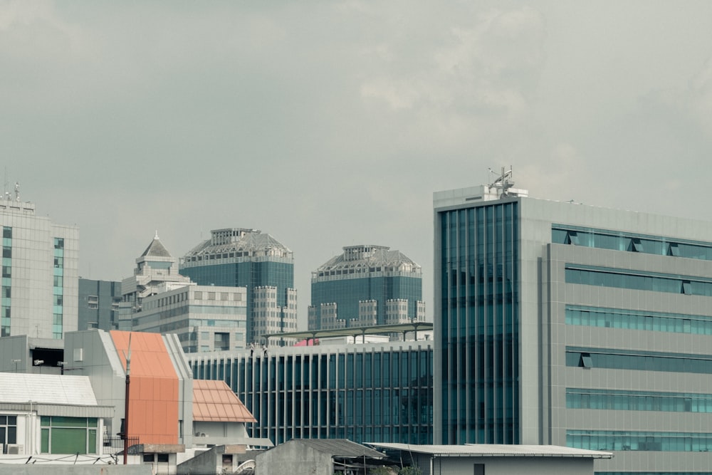 gray and blue curtain glass wall buildings during daytime