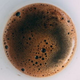 Close-up of our special barista coffee being poured, showcasing its rich crema and inviting aroma.