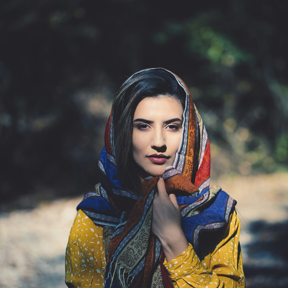 woman using multicolored scarf in selective focus photography