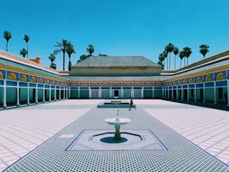 person walking near Marrakech building during daytime