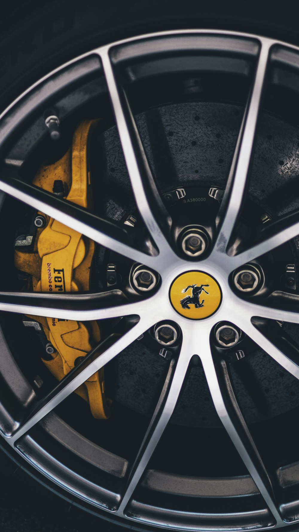 gray Ferrari car wheel with tire