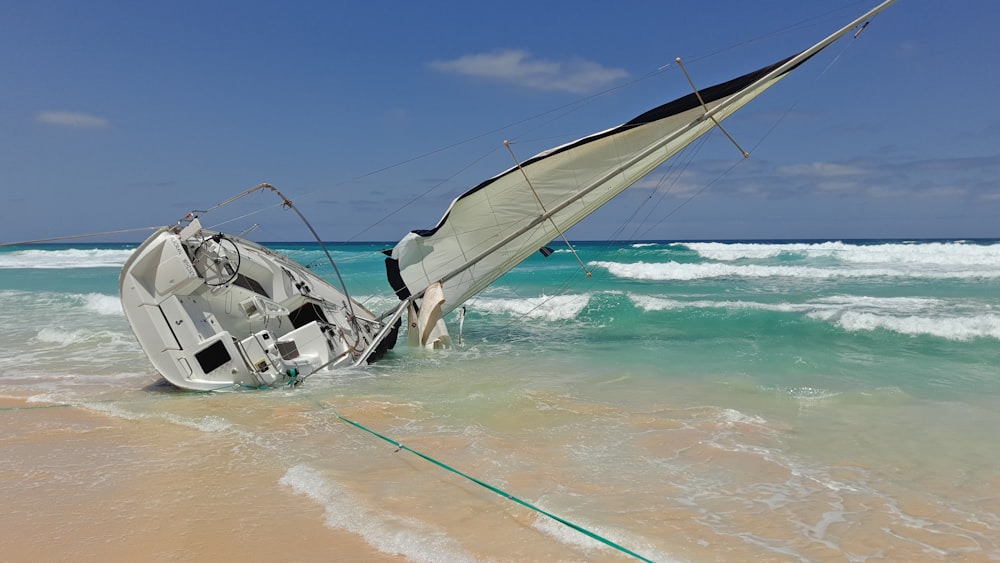 white and gray boat on seashore