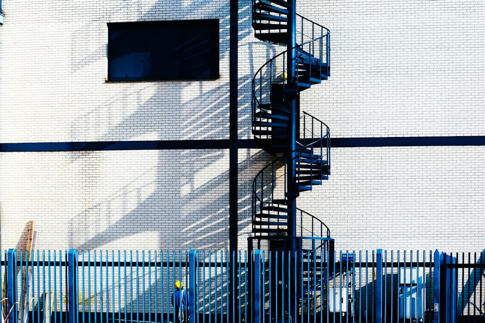 spiral stairs in front of white building