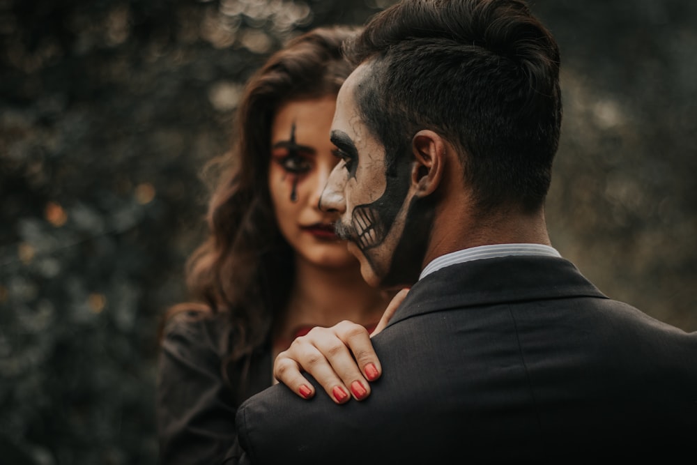 man and woman with halloween paint on face
