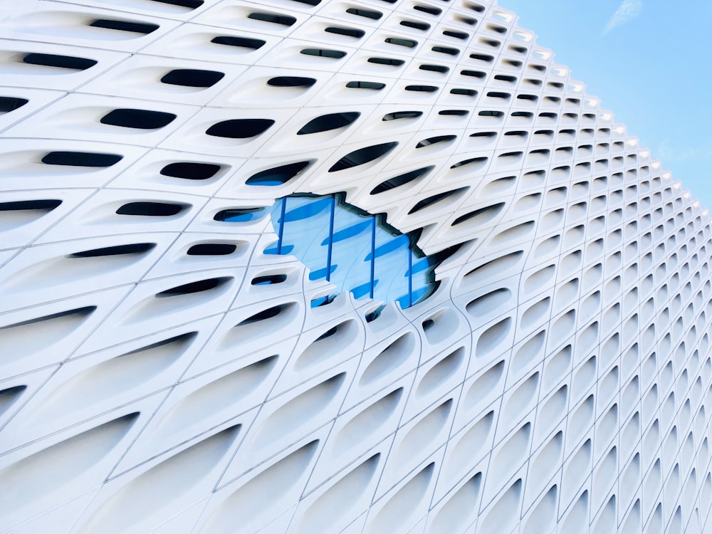 macro photography of white building under blue and white sky during daytime