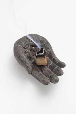 An intricately carved wooden tool glowing softly with ancestral energy.