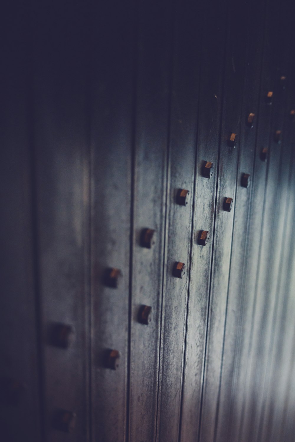 a metal door with a bunch of knobs on it