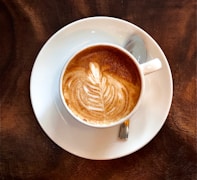 white ceramic teacup with latte