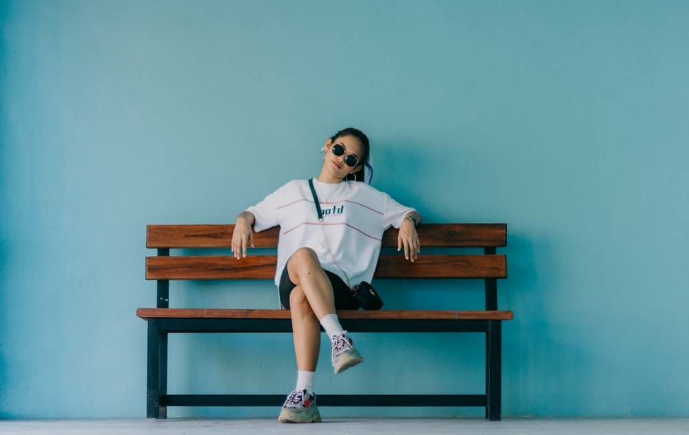 woman sitting on brown bench