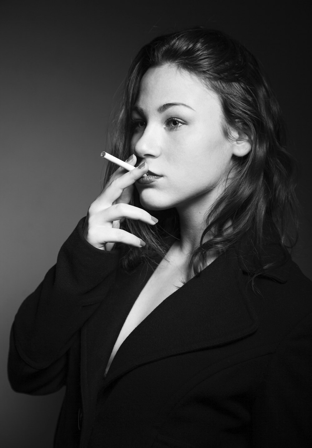 woman wearing black blazer smoking