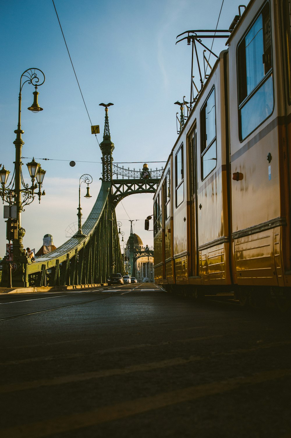 yellow tram viewing bridge during daytime