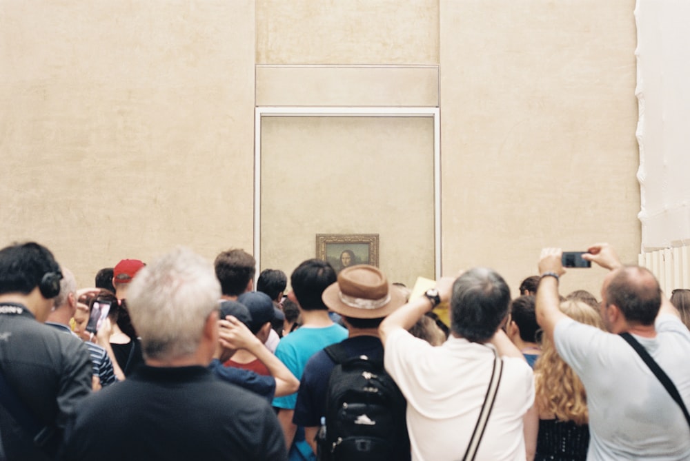 people taking photo of Mona Lisa painting