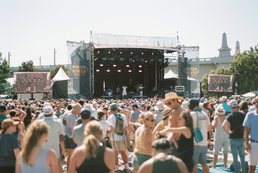 people on open space near stage during daytime