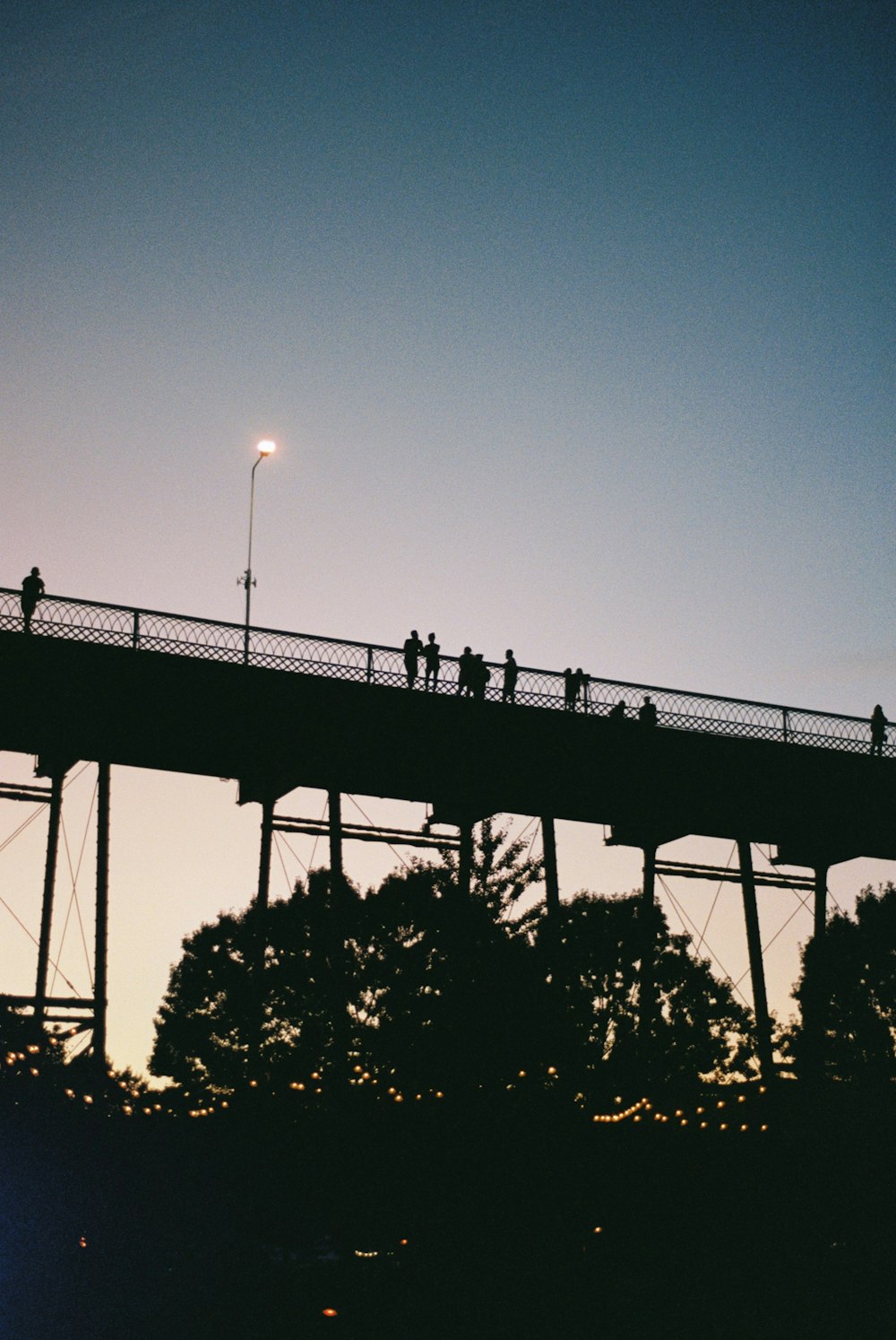 silhouette photography of people on bridge