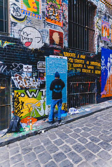 A vibrant urban artist applying custom prints on a hoodie in a modern studio.