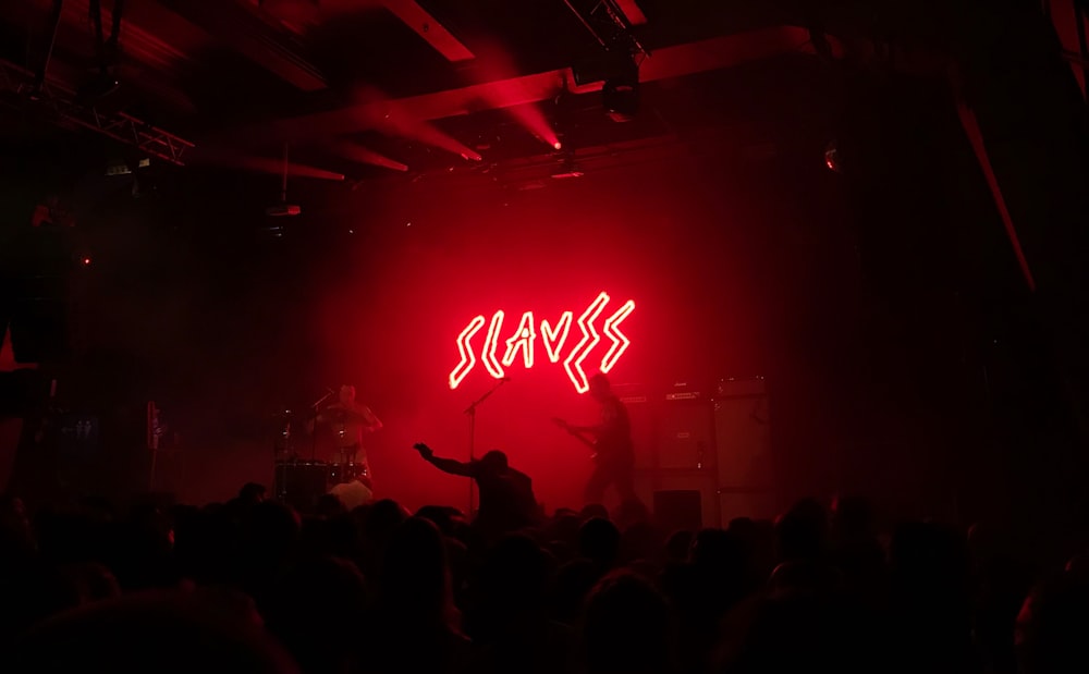 Slaves lighted signage on stage