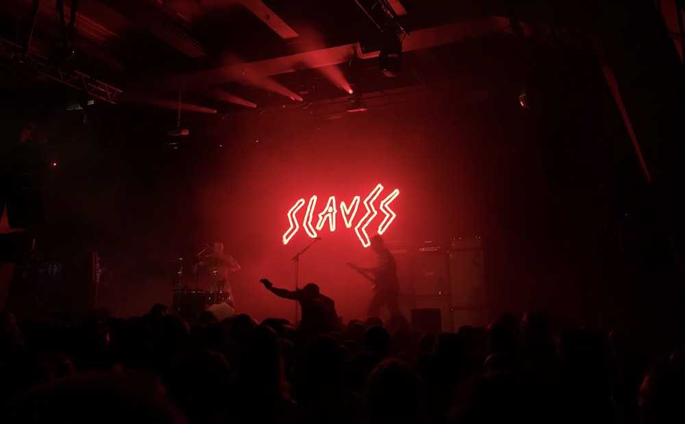 Slaves lighted signage on stage