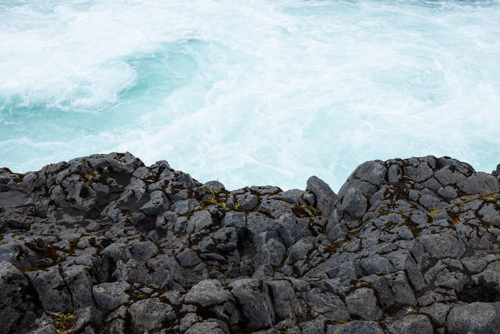 brown rocks near body of water