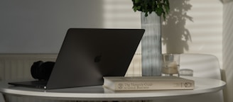 silver MacBook on table