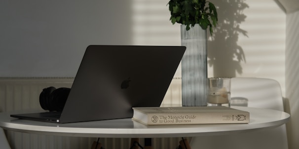 silver MacBook on table