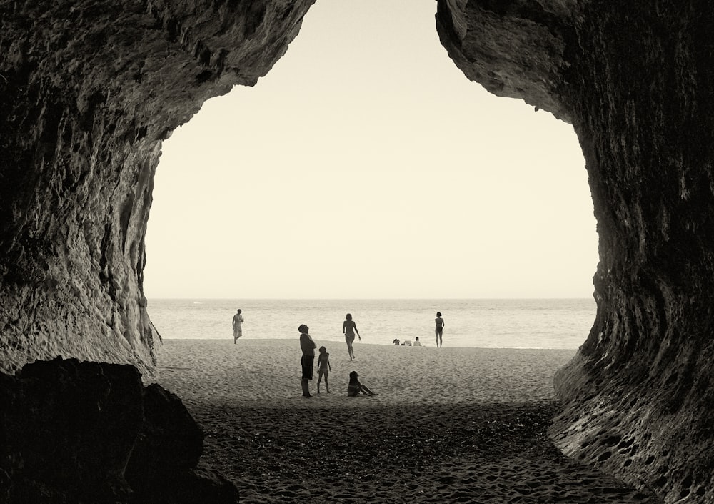 grayscale photography of people on seashore