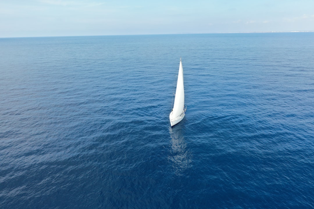 white sailboat on body of water,