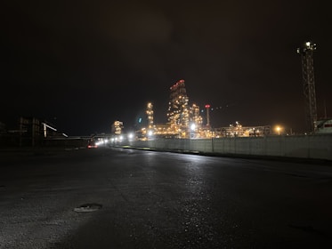 Nighttime shot of an industrial facility illuminated, showcasing Al Mozil's precision and scale.