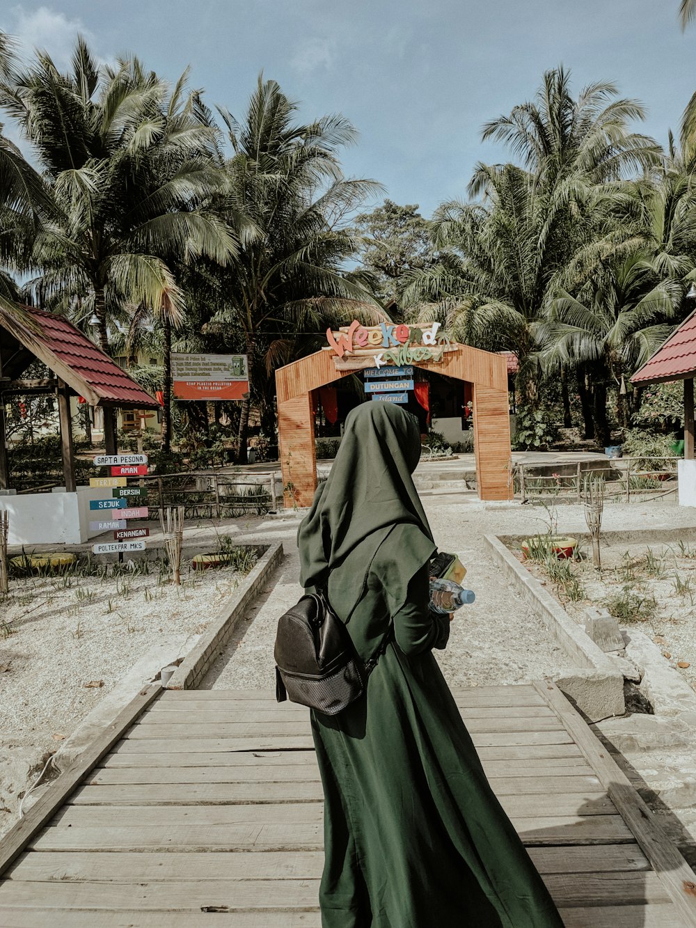 woman standing on footbridge