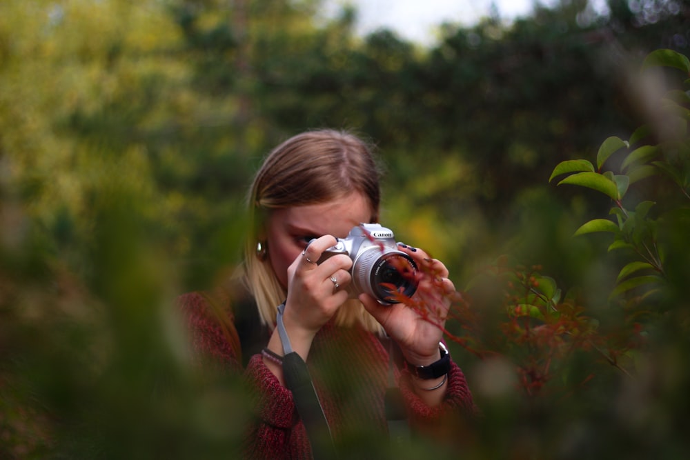 woman taking photo using DSLR camera