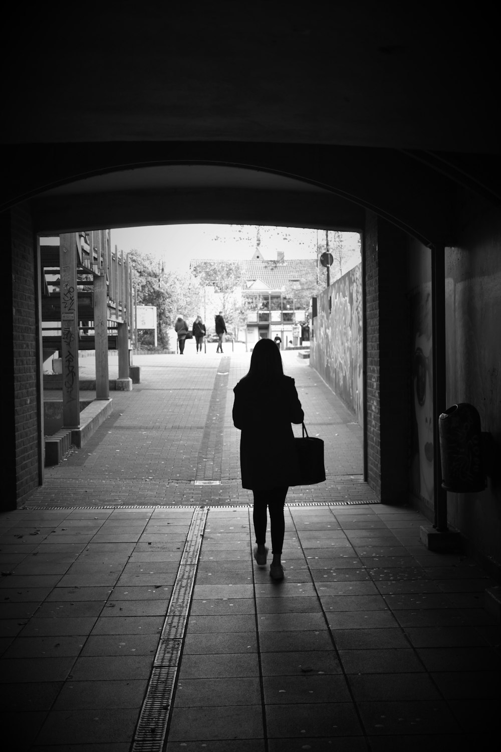 woman standing beside building