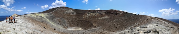 Happy travelers enjoying a guided tour through a volcanic crater.
