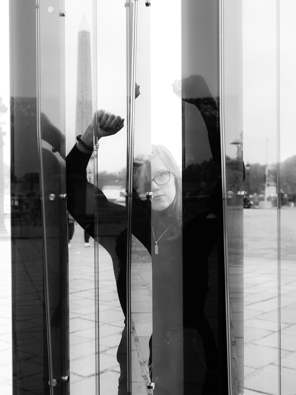 woman near clear glass wall