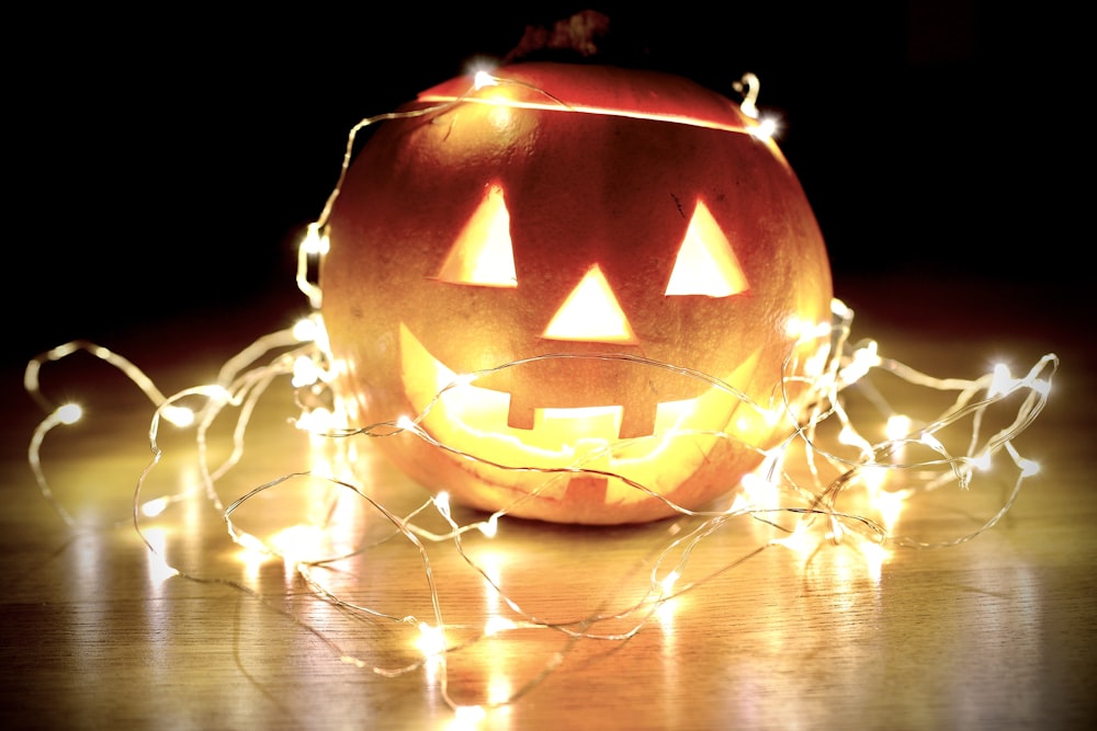 lighted string lights wrapped on Jack-O'-Lantern