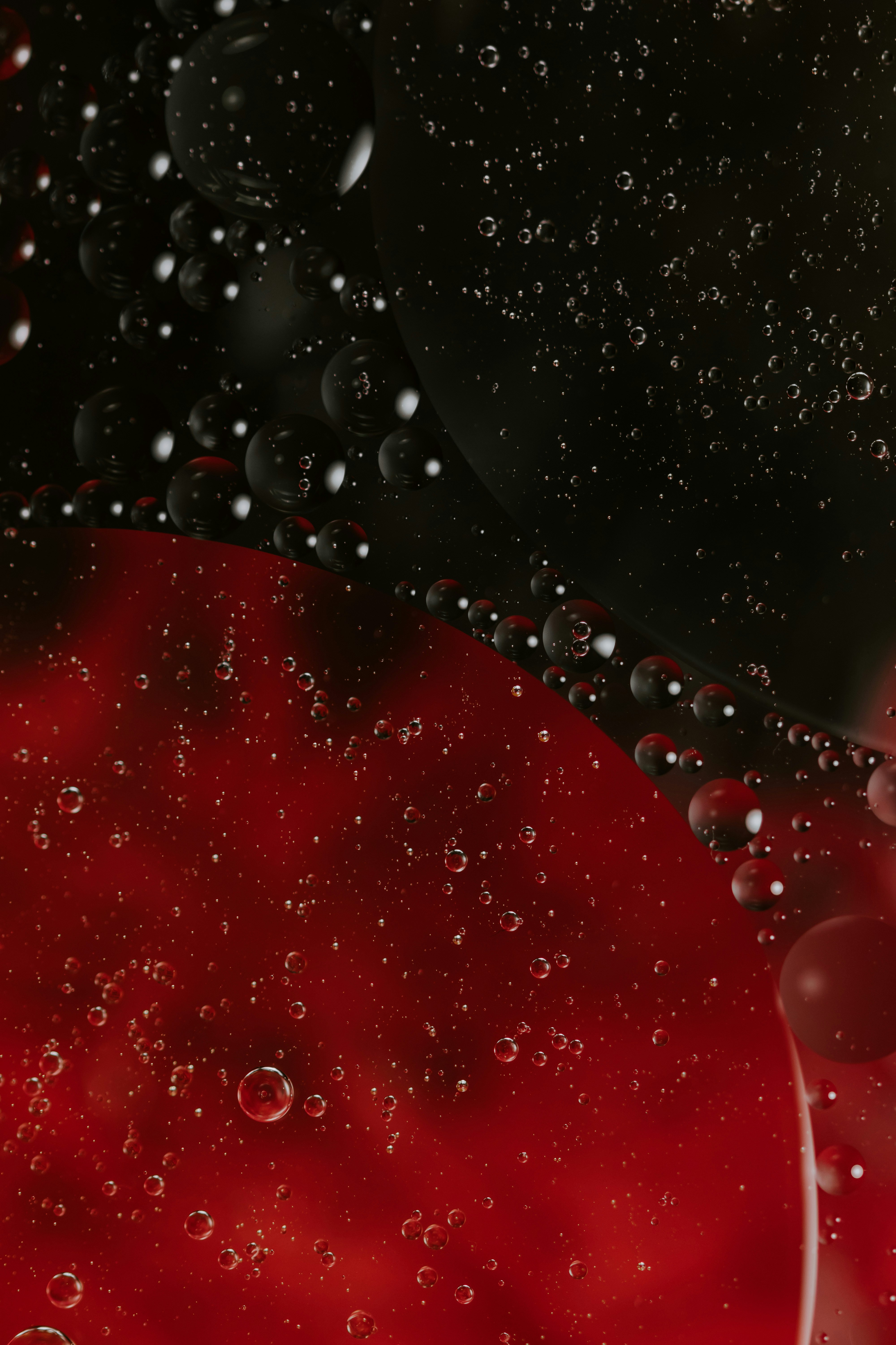 a red and black background with water droplets