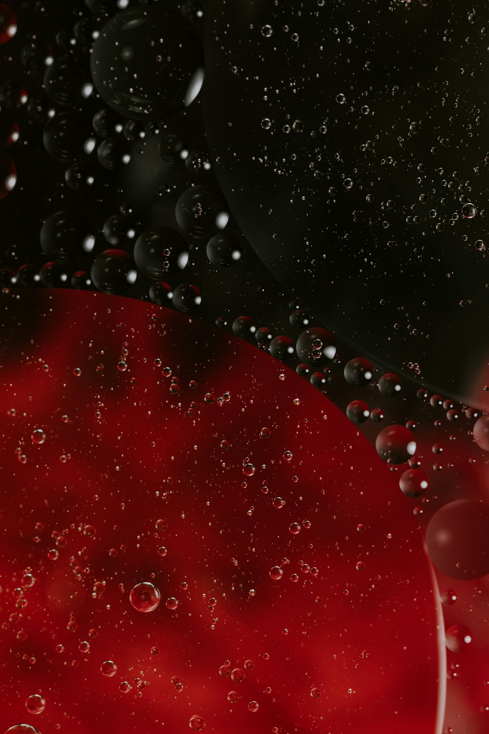 a red and black background with water droplets