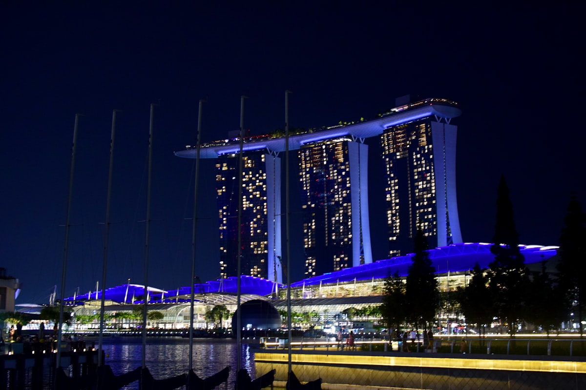 Singapore March — Marina Bay Sands hotel towers illuminated at night over the waterfront