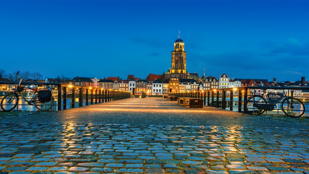 city with high-rise buildings viewing body of water during night time